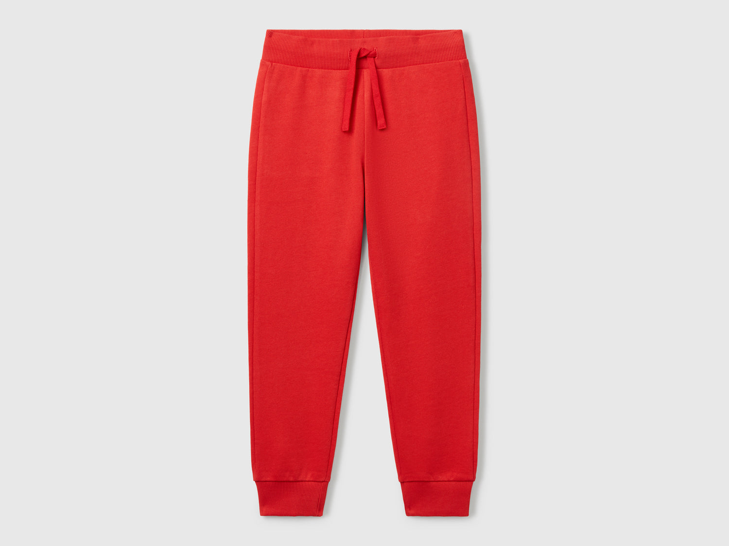 Pantaloni sportivi con coulisse da bambino rosso | Benetton Outlet