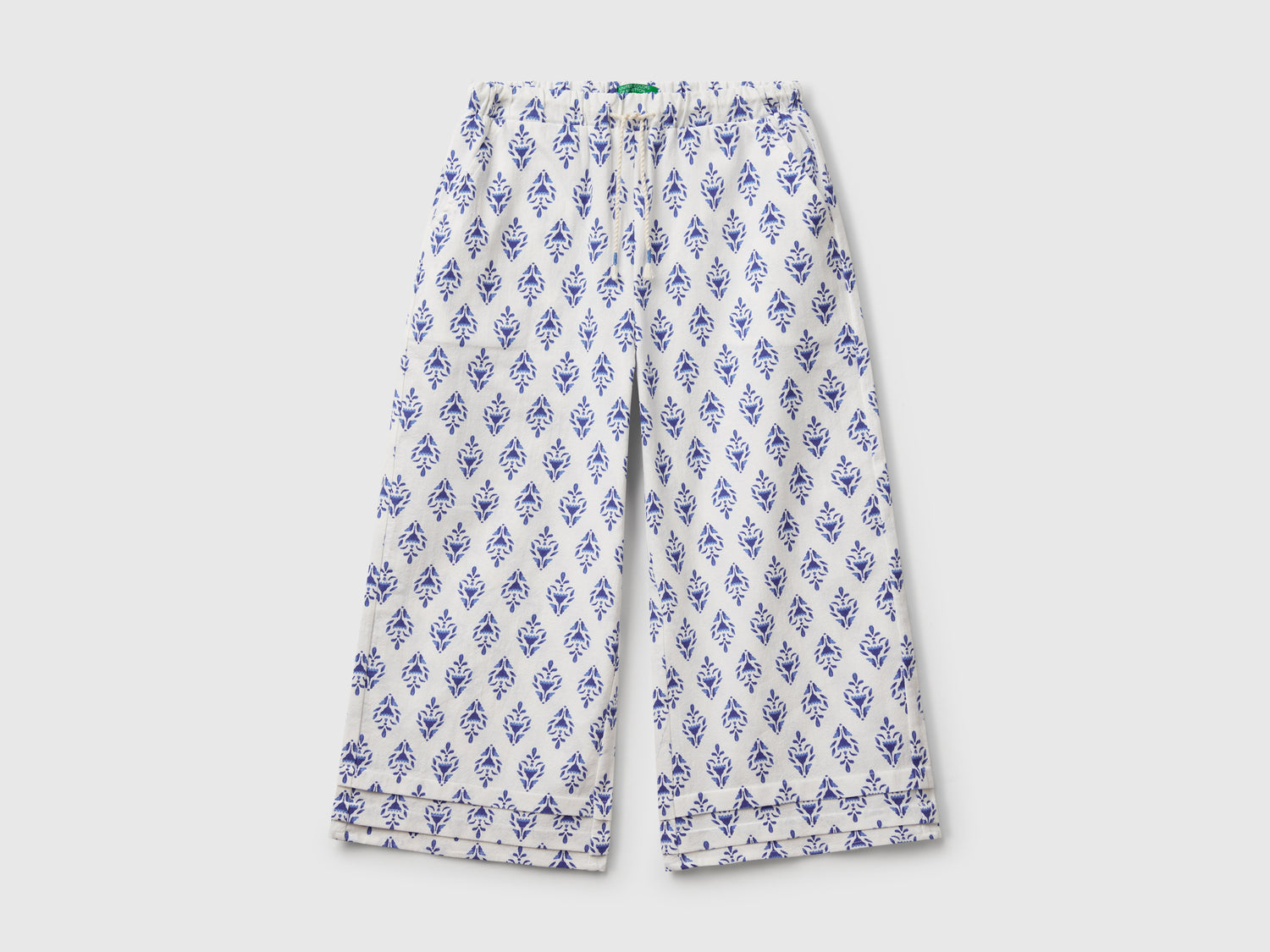 Pantaloni fantasia con gamba ampia da bambina blu | Benetton Outlet