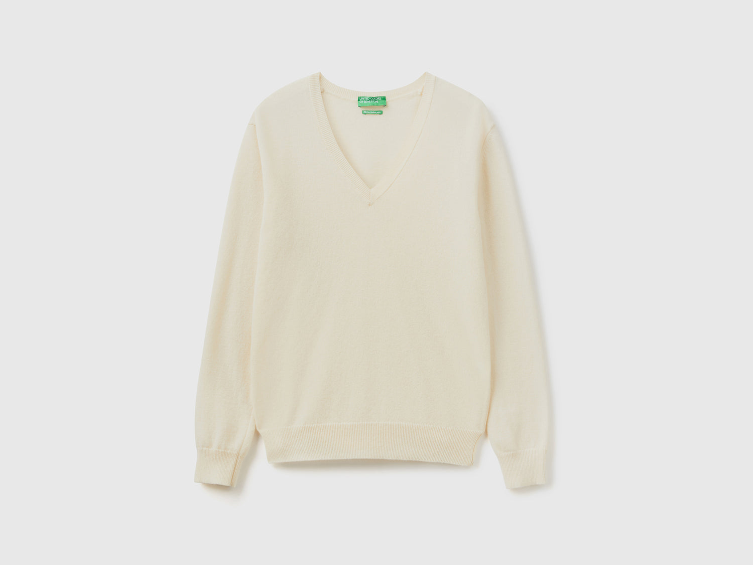 Maglia con scollo a V panna in pura lana Merino da donna bianco panna | Benetton Outlet