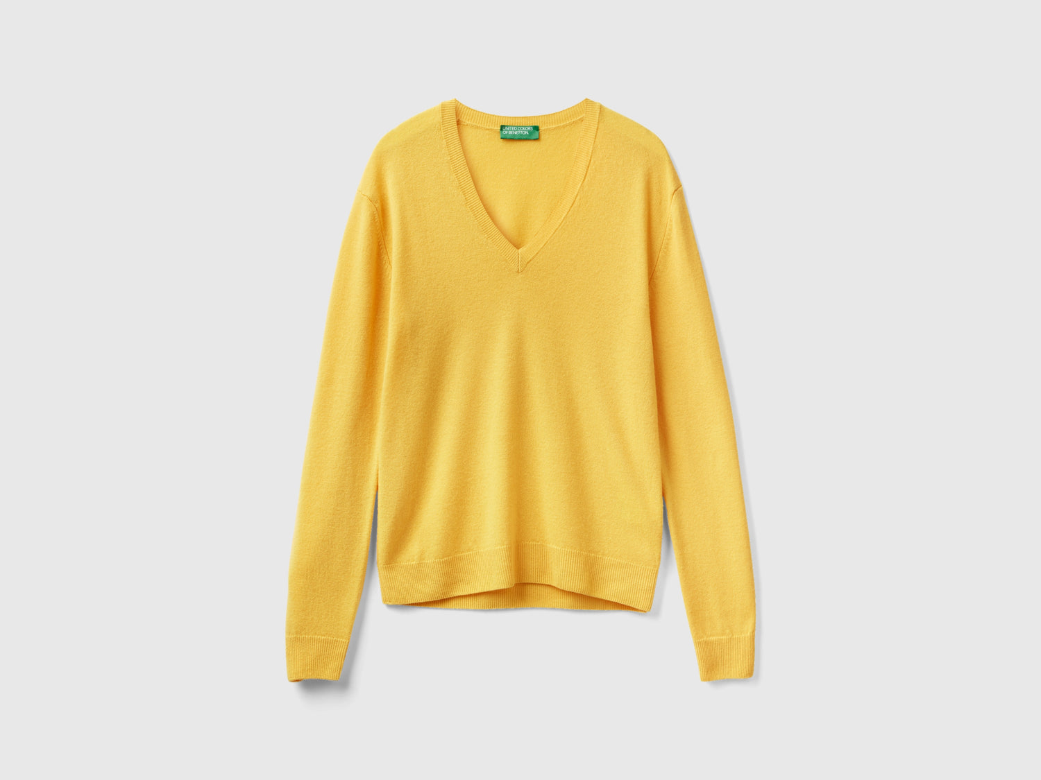 Maglia con scollo a V in pura lana Merino da donna giallo | Benetton Outlet