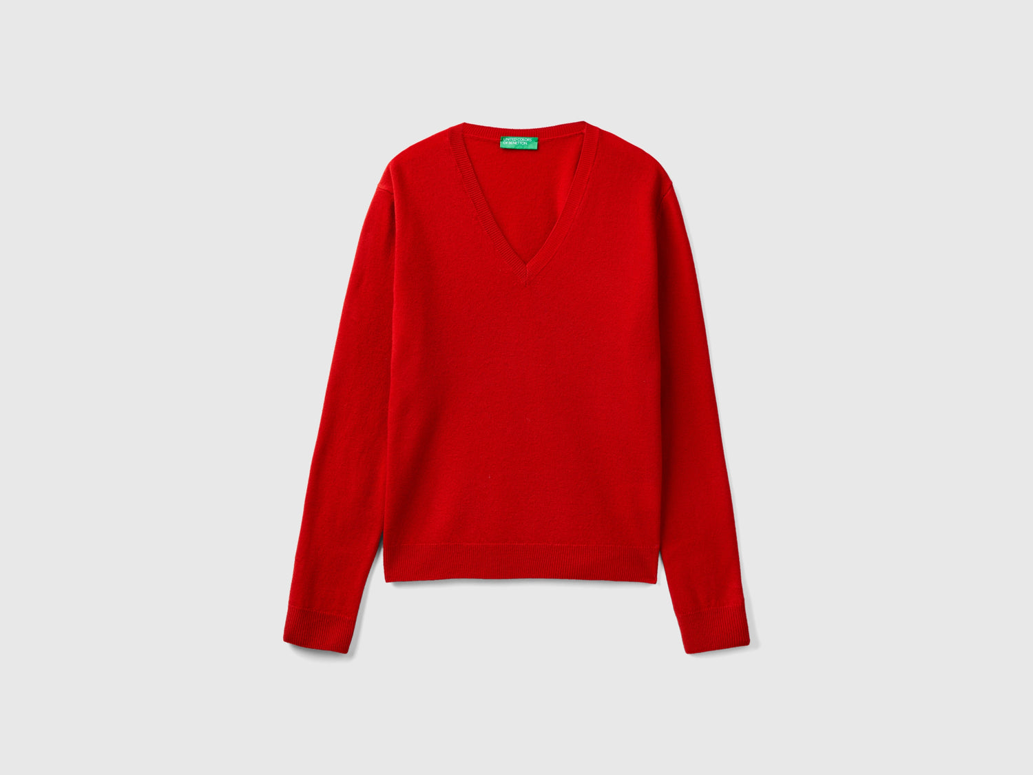 Maglia con scollo a V in pura lana Merino da donna rosso | Benetton Outlet