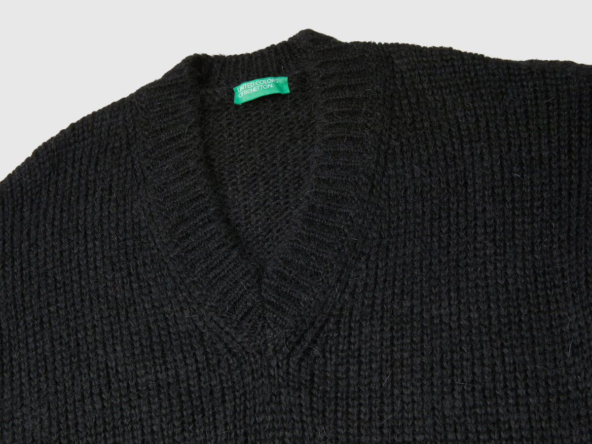 Sweater with perforated sleeves
