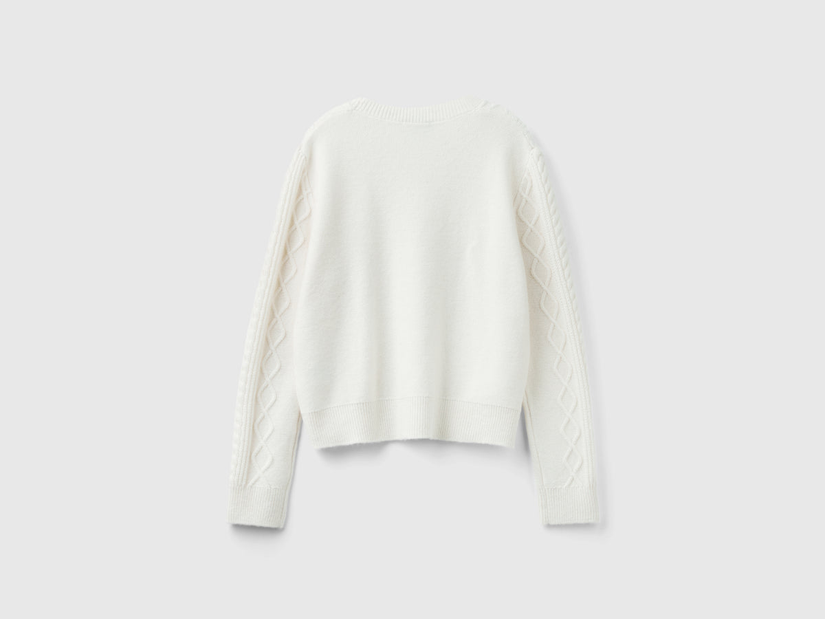 Sweater with braids and rhinestones