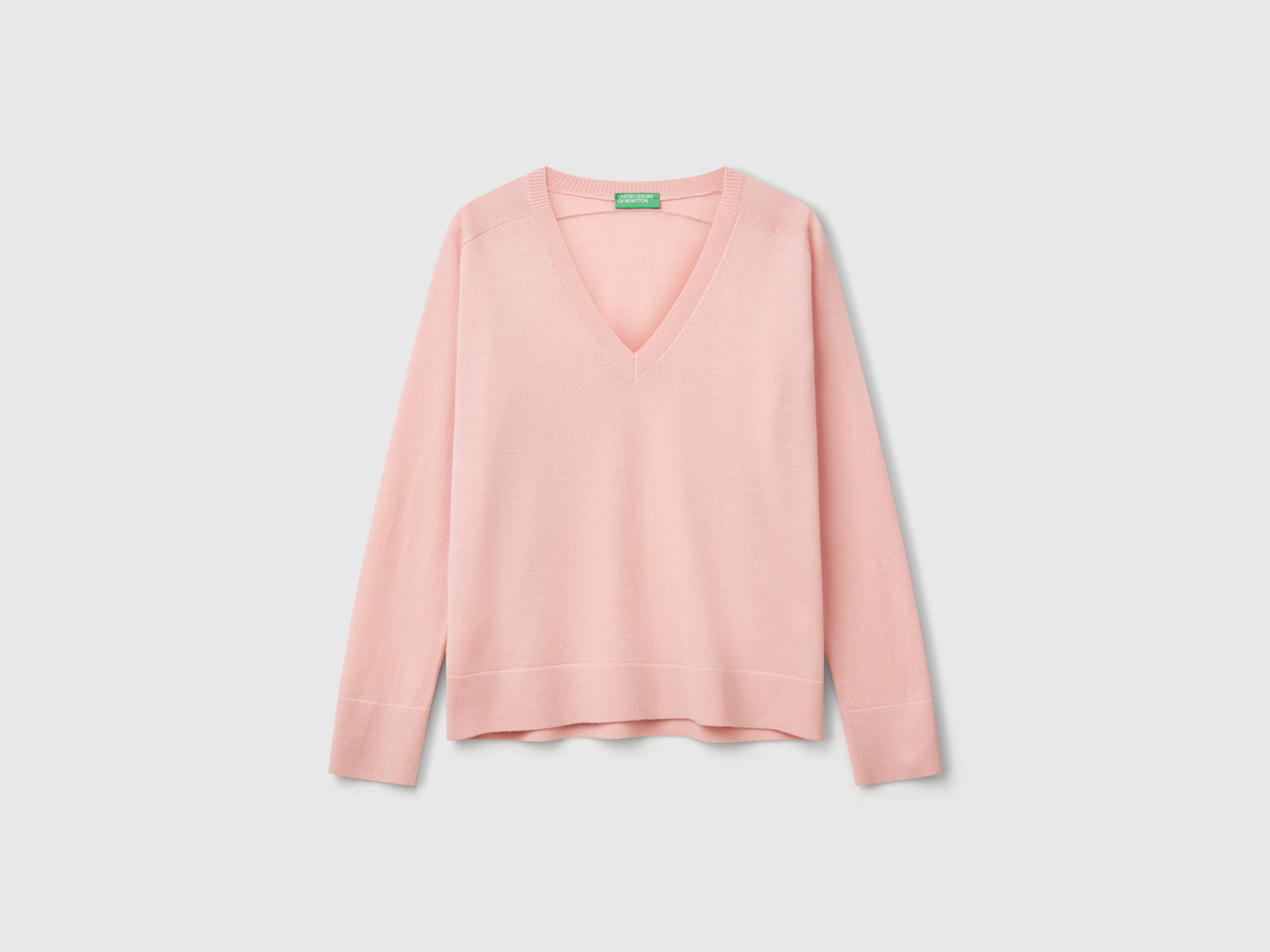 Maglia con scollo a V in pura lana Merino da donna rosa tenue | Benetton Outlet