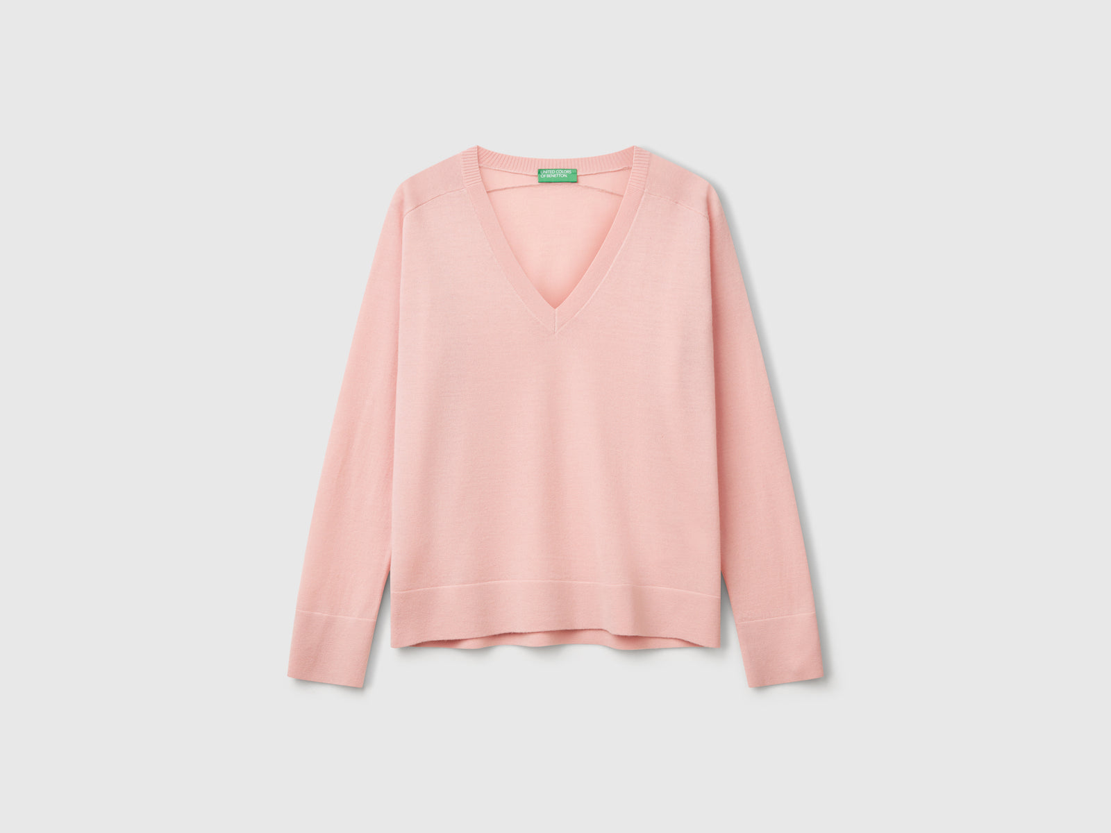 Maglia con scollo a V in pura lana Merino da donna rosa tenue | Benetton Outlet