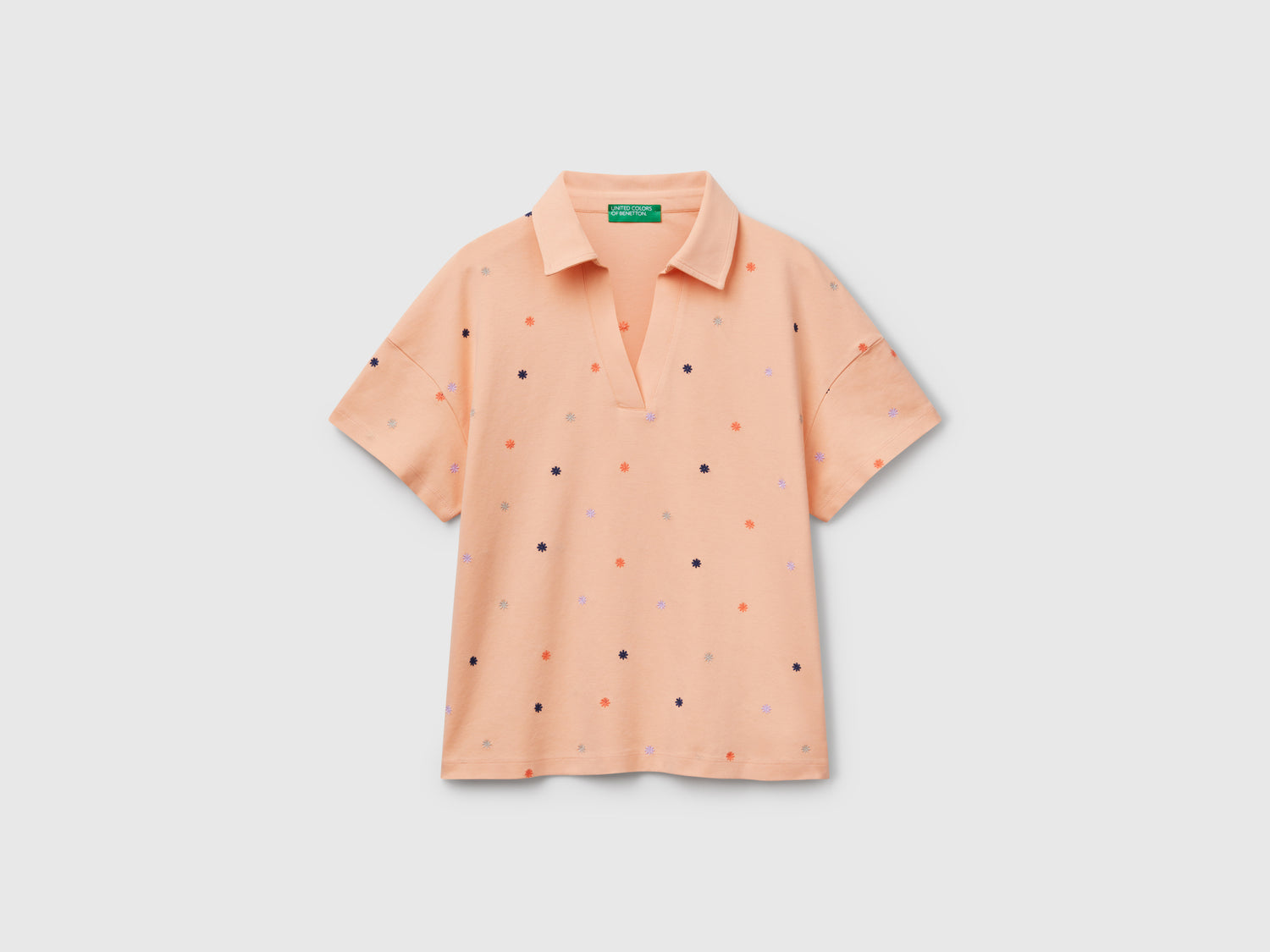 Polo con ricamo fiori da donna pesca | Benetton Outlet