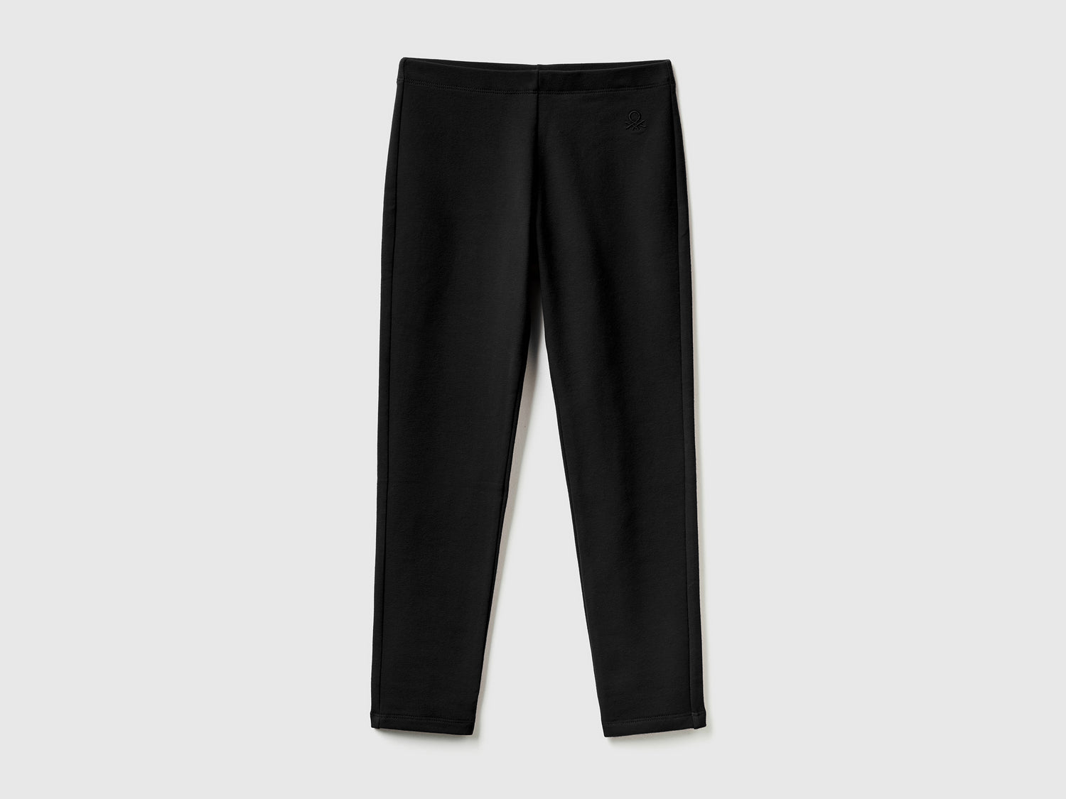 Leggings in felpa stretch da bambina nero | Benetton Outlet