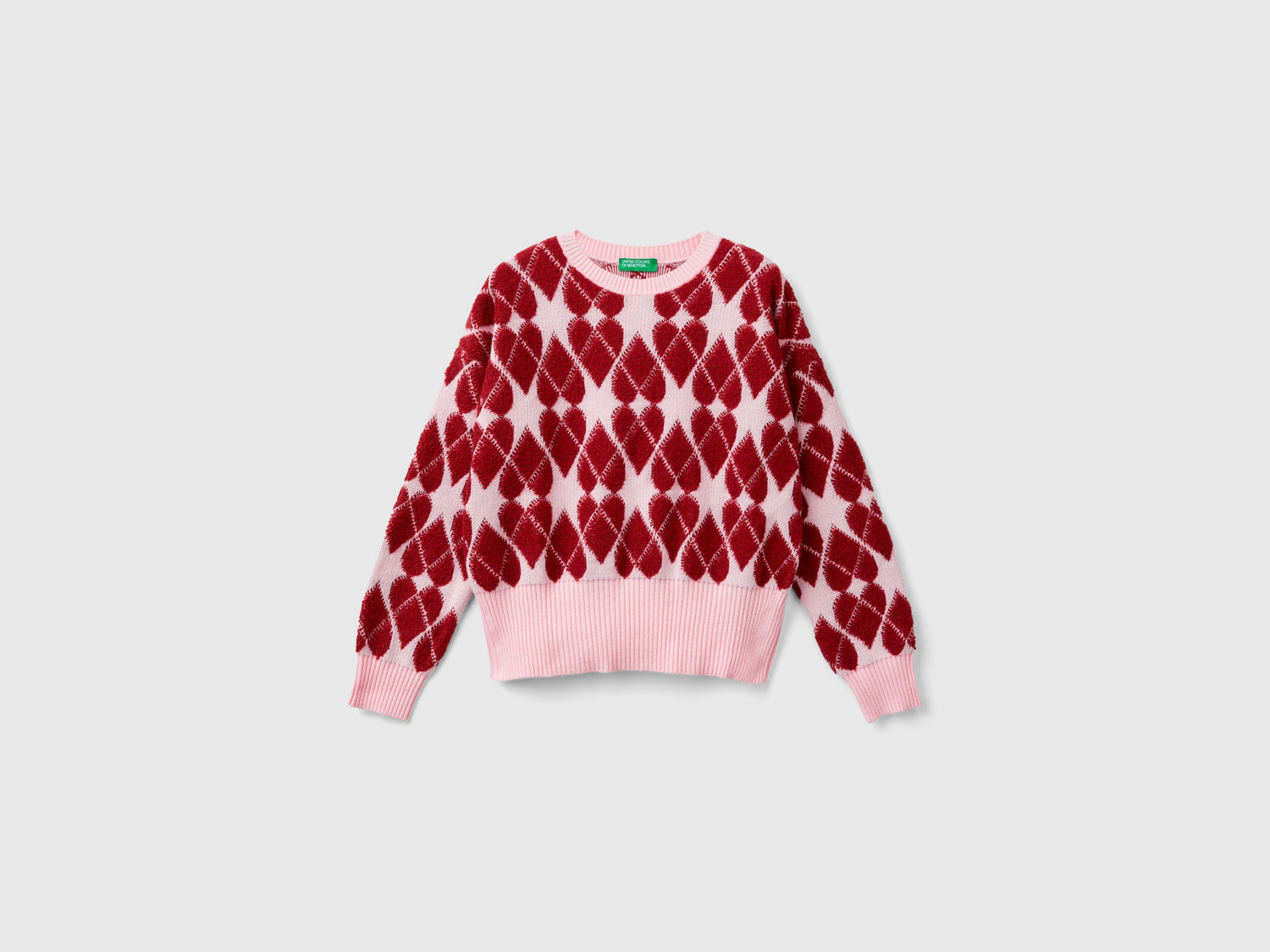 Maglia a cuori jacquard da bambina rosa | Benetton Outlet