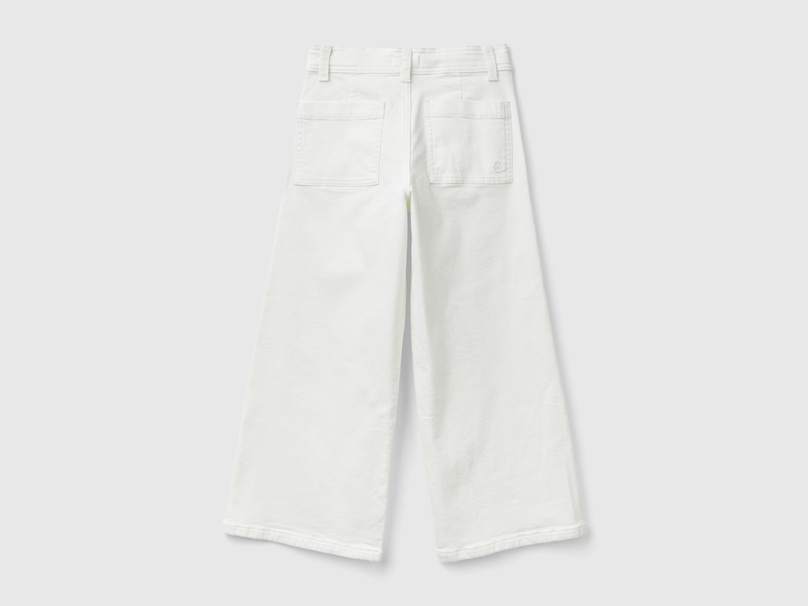 Pantaloni ampi in cotone stretch da bambina bianco panna 2 | Benetton Outlet