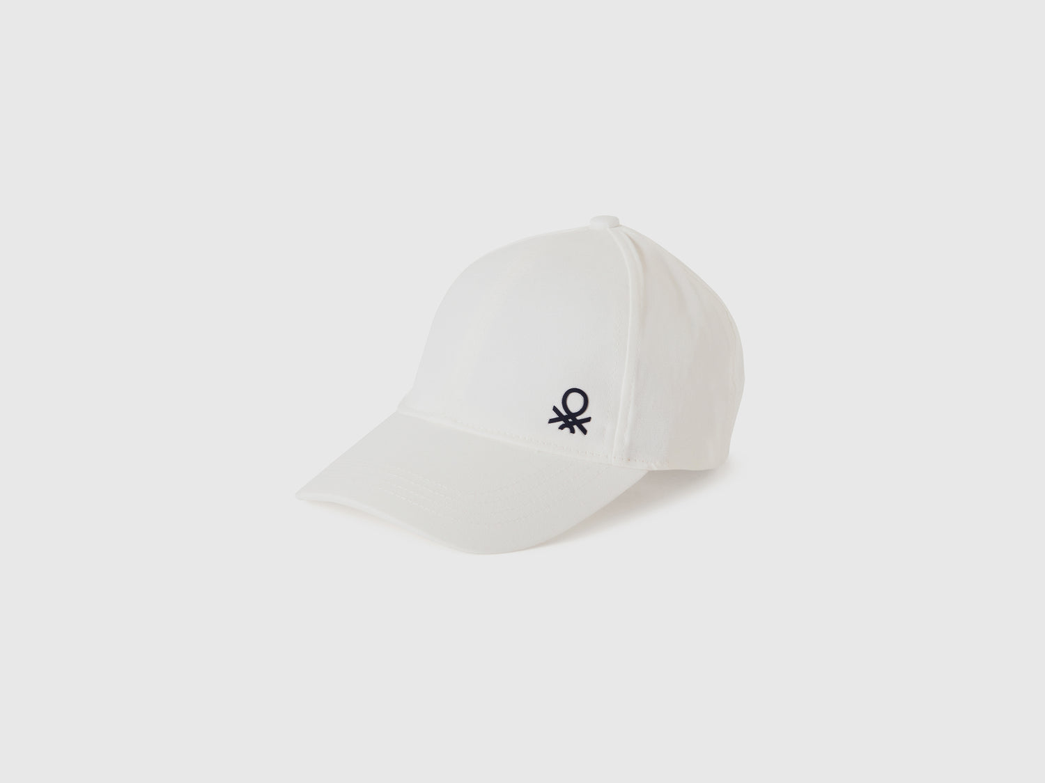 Cappellino con visiera da bimbo bianco | Benetton Outlet