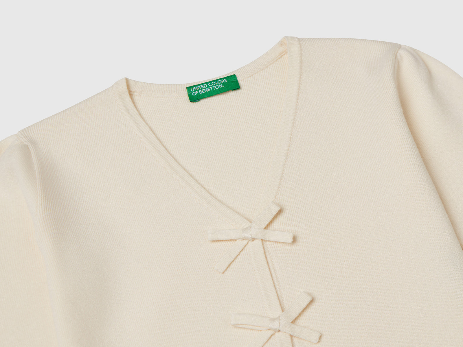 Cardigan con fiocchetti da bimba bianco panna 3 | Benetton Outlet