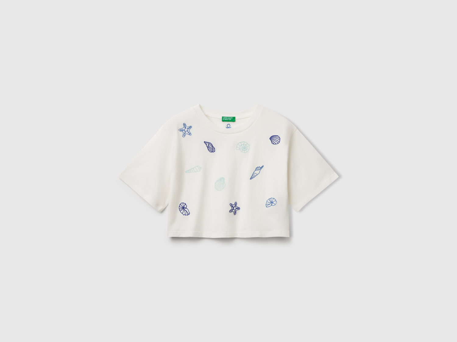T-shirt con ricamo conchiglie da bambina bianco panna | Benetton Outlet