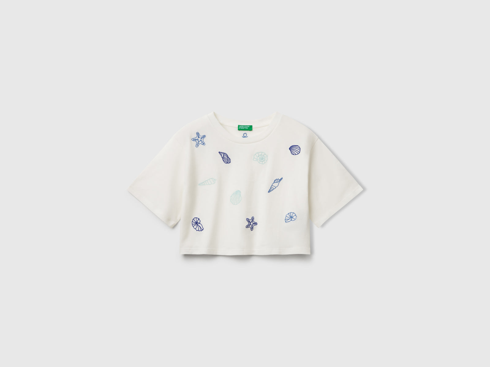 T-shirt con ricamo conchiglie da bambina bianco panna | Benetton Outlet