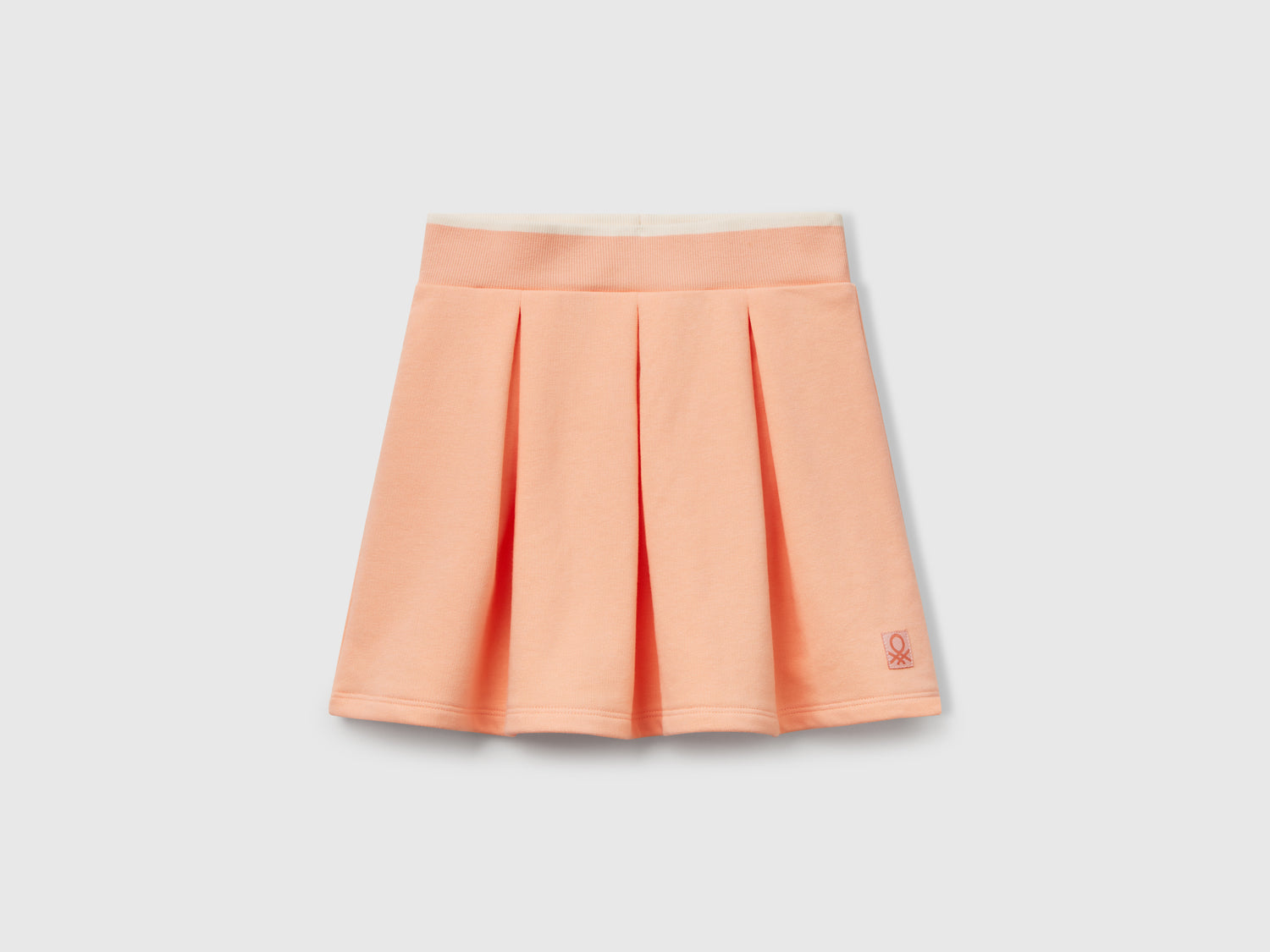 Gonna in felpa con pieghe da bambina pesca | Benetton Outlet
