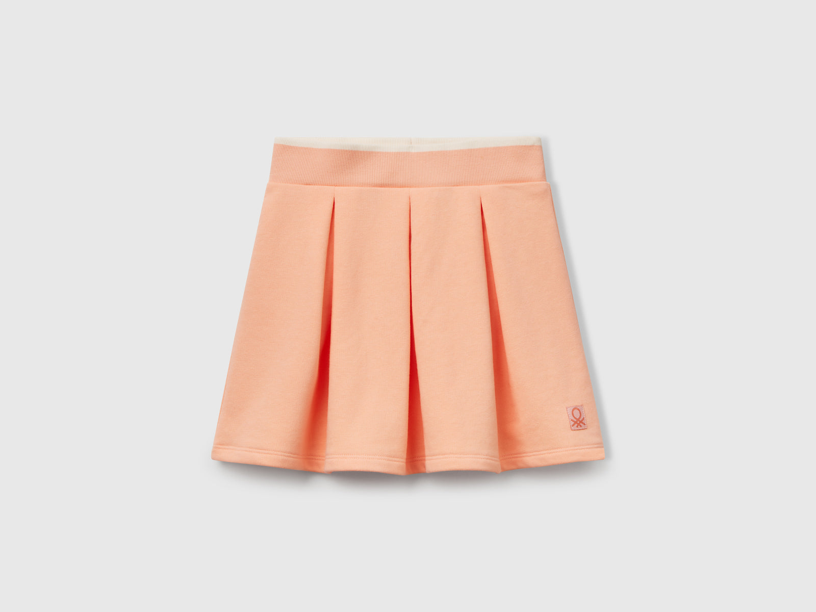 Gonna in felpa con pieghe da bambina pesca | Benetton Outlet