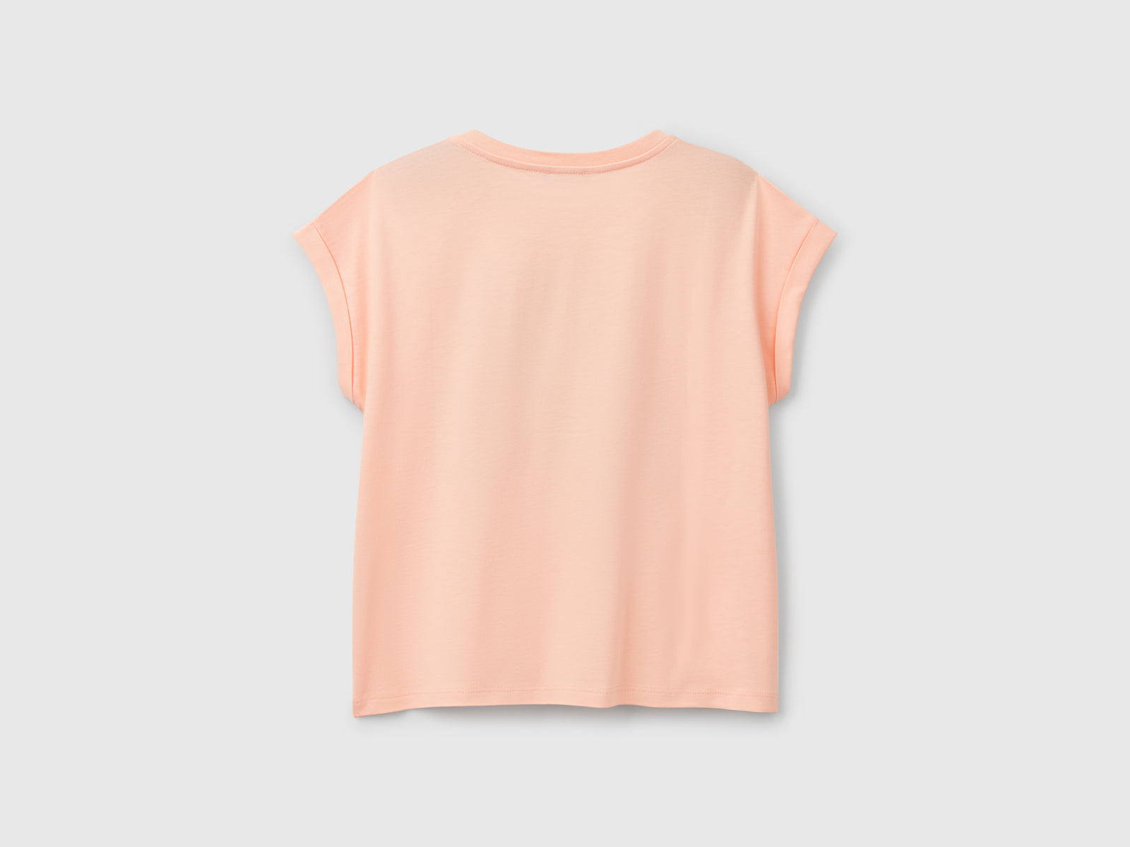 Maglietta boxy fit con stampa e glitter da bambina pesca 2 | Benetton Outlet