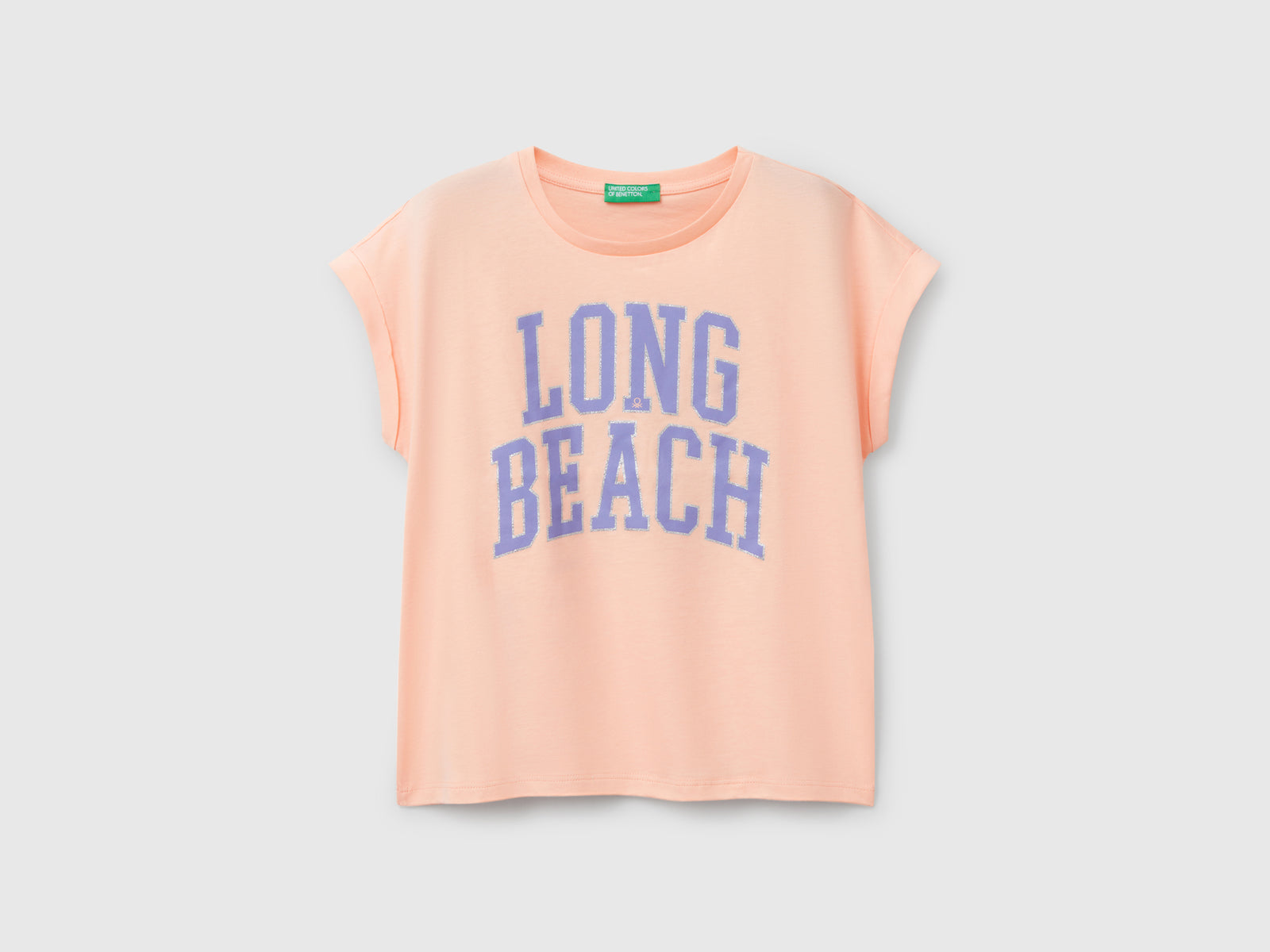 Maglietta boxy fit con stampa e glitter da bambina pesca | Benetton Outlet
