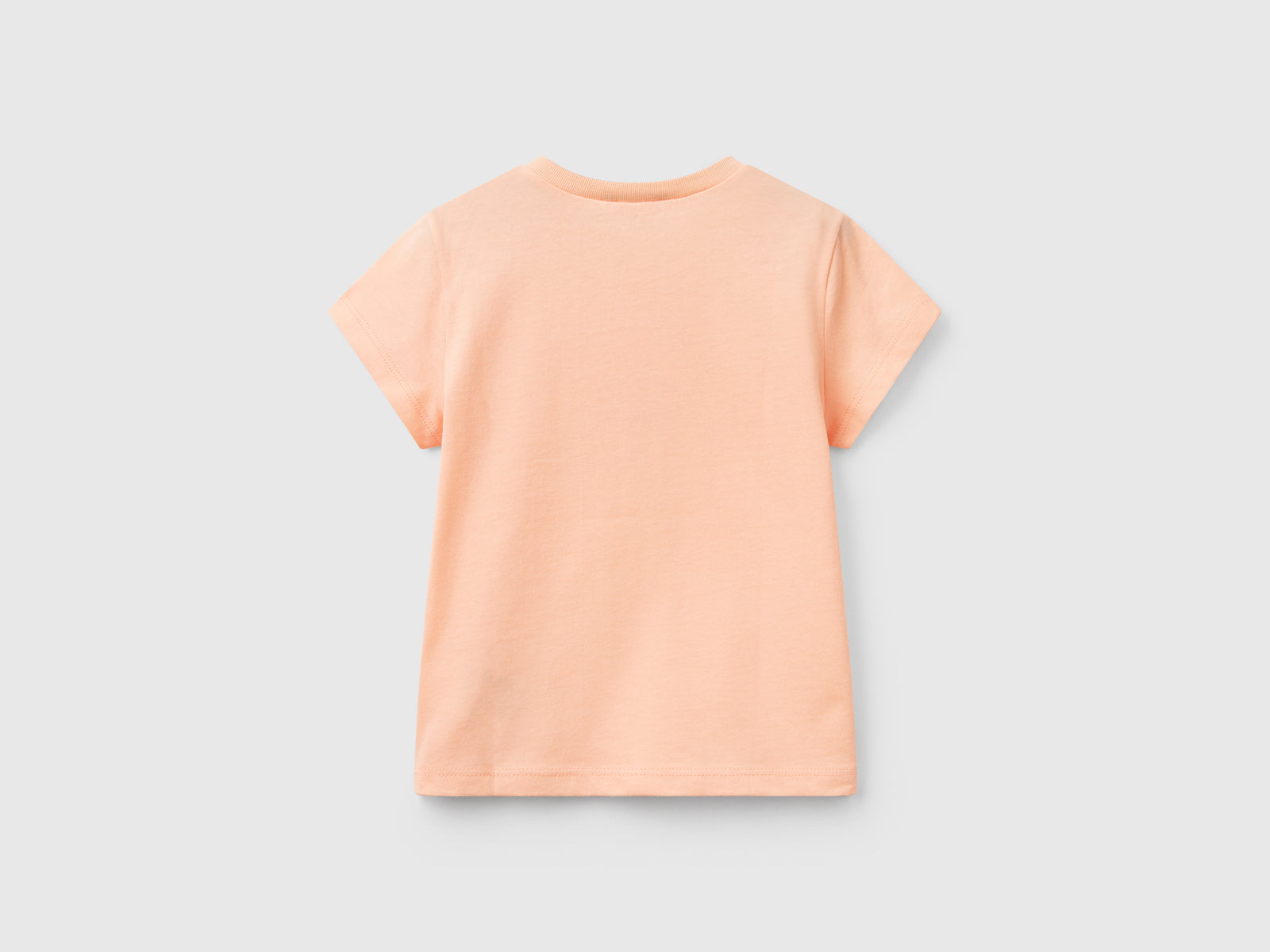 Maglietta con stampa glitter da bimba pesca 2 | Benetton Outlet