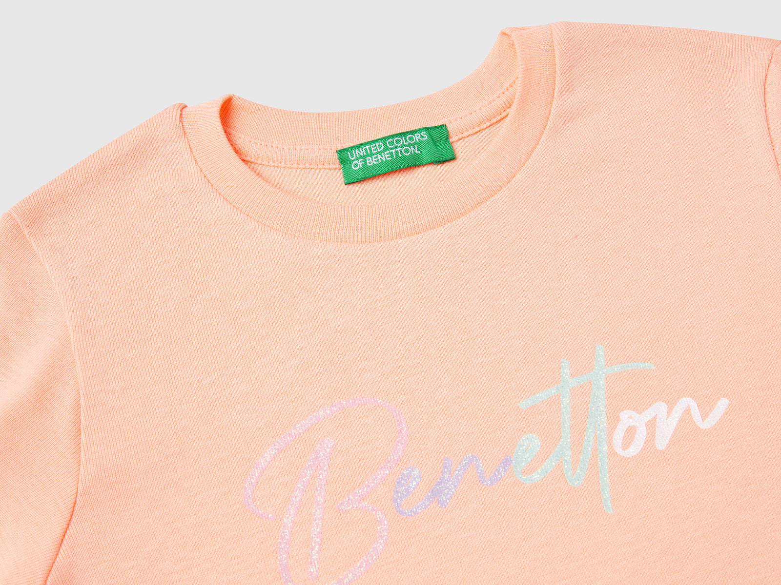 T-shirt slim fit con stampa glitter da bimba pesca 3 | Benetton Outlet
