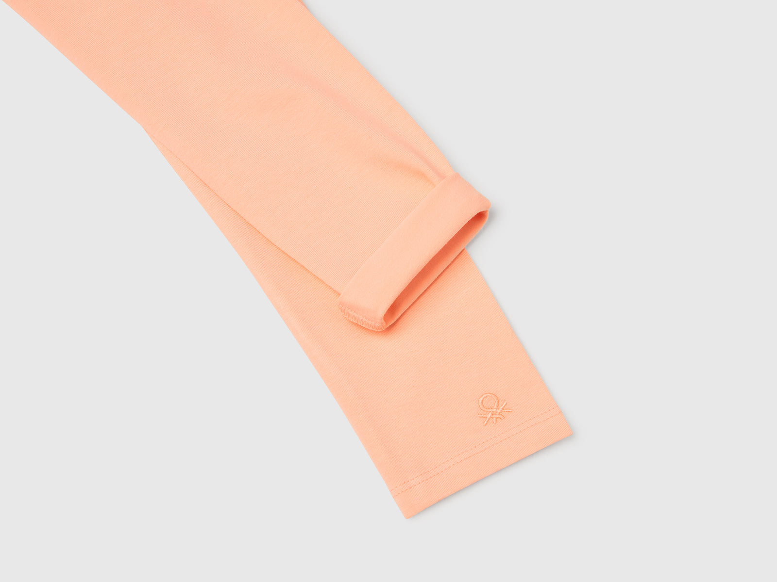 Leggings in cotone stretch con logo da bambina pesca 3 | Benetton Outlet