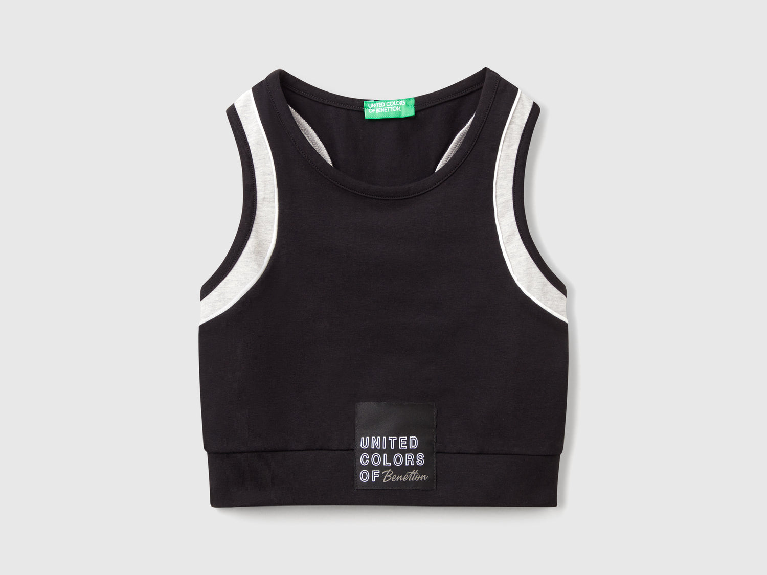 Top sportivo con piping da bambina nero | Benetton Outlet