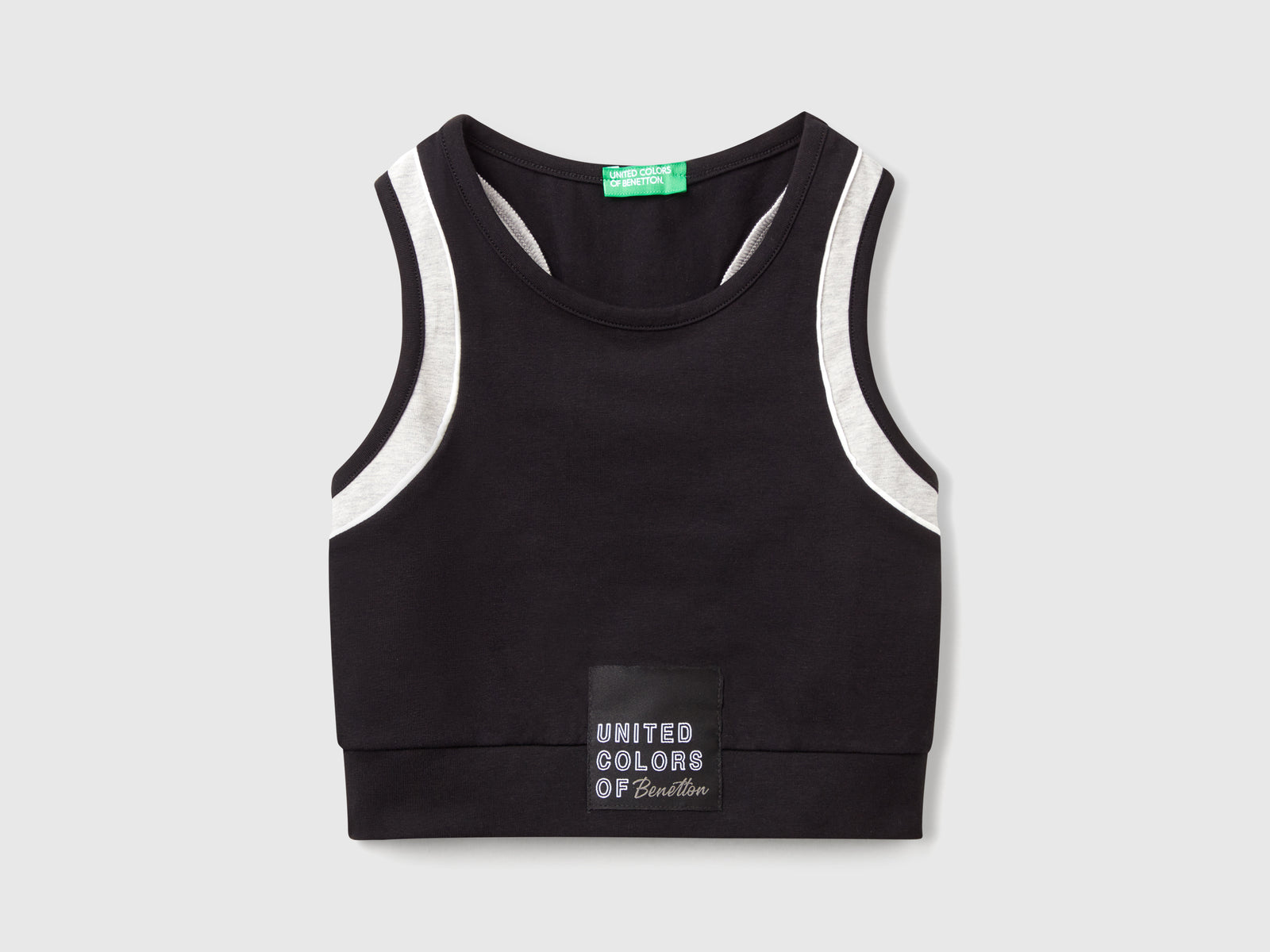 Top sportivo con piping da bambina nero | Benetton Outlet