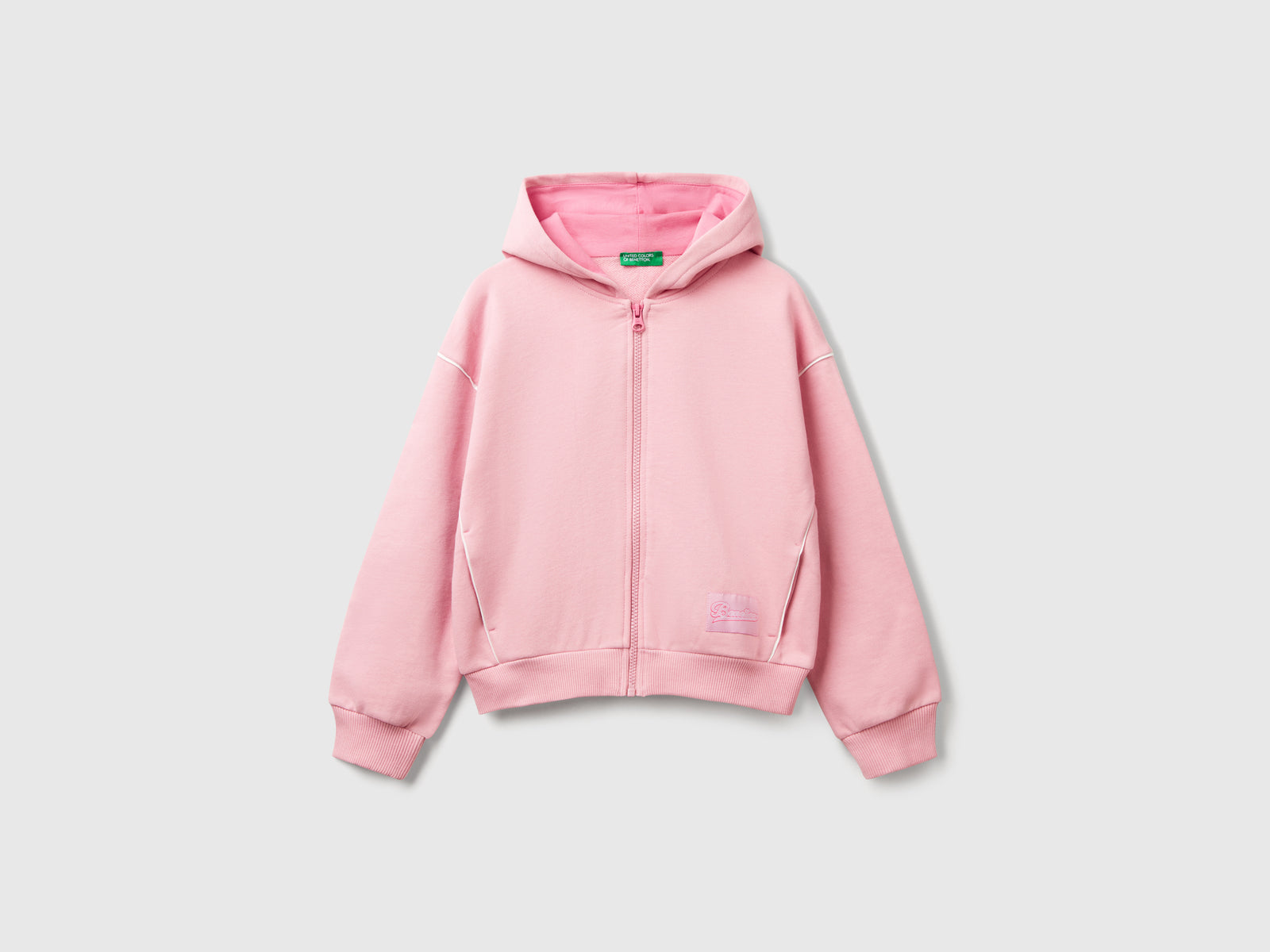 Felpa over fit con cappuccio da bambina rosa | Benetton Outlet