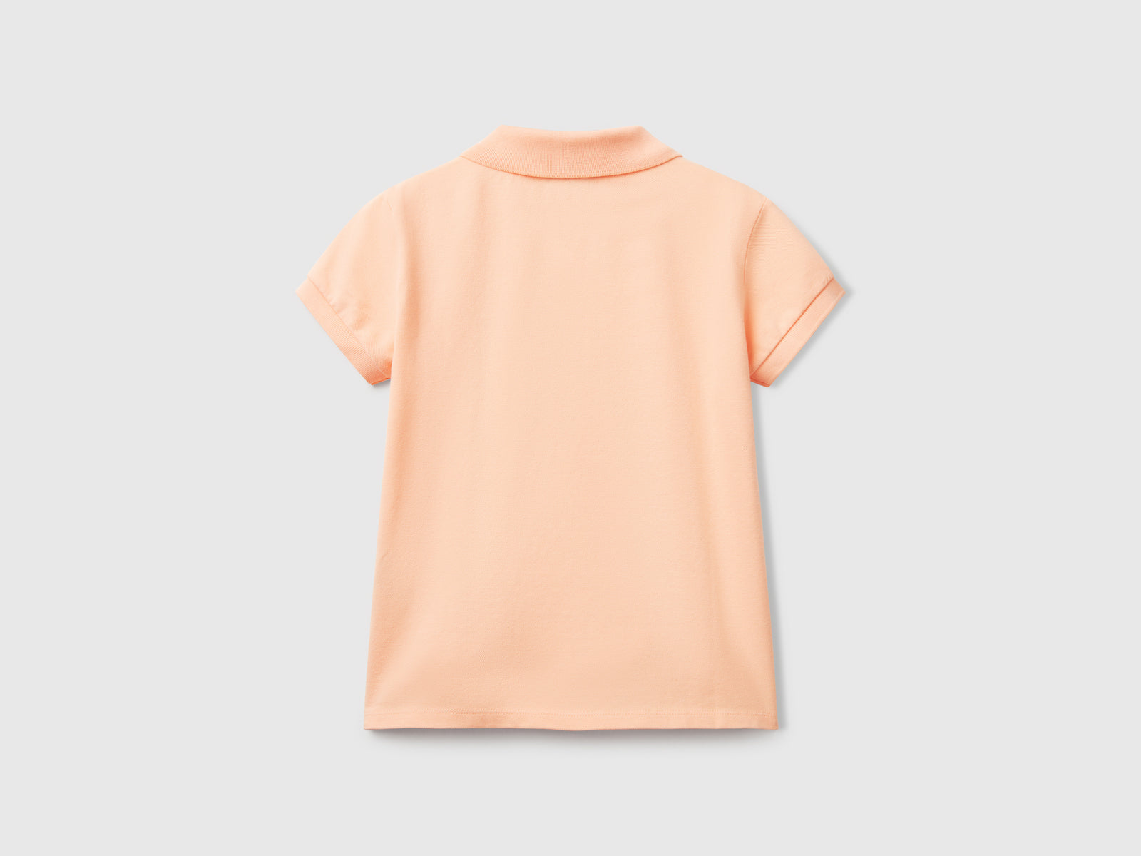 Polo manica corta in cotone da bambina pesca 2 | Benetton Outlet