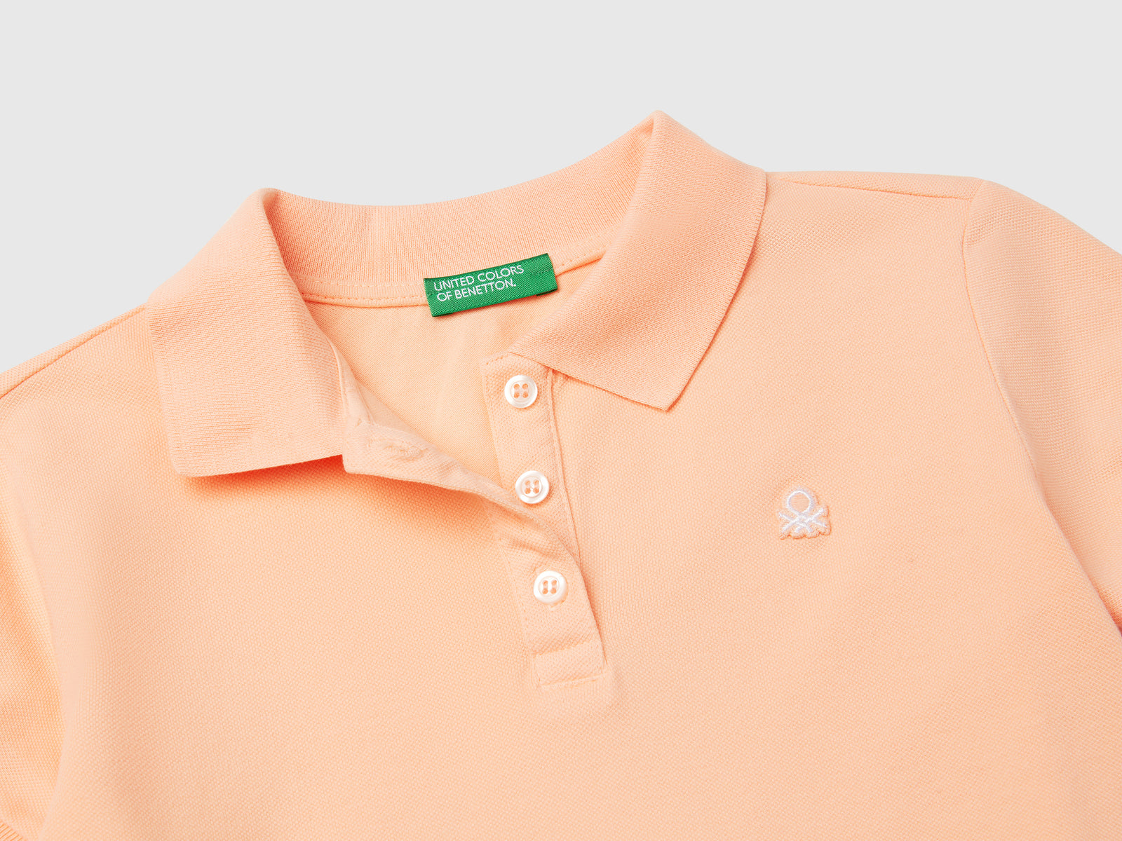 Polo manica corta in cotone da bambina pesca 3 | Benetton Outlet