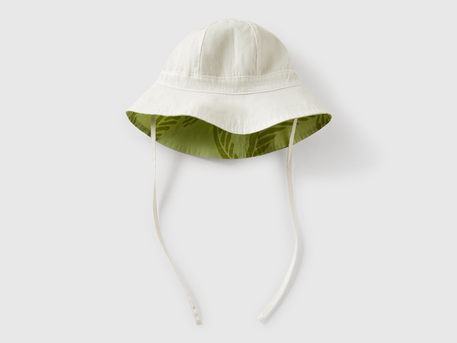 Cappello reversibile con stampa tropicale da neonato verde chiaro | Benetton Outlet