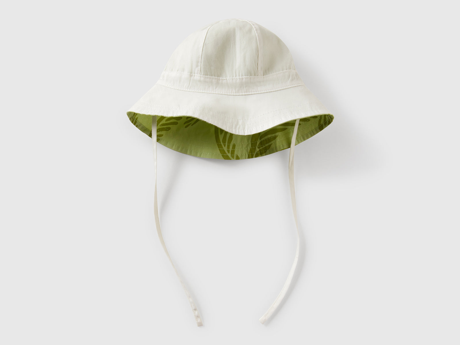 Cappello reversibile con stampa tropicale da neonato verde chiaro | Benetton Outlet