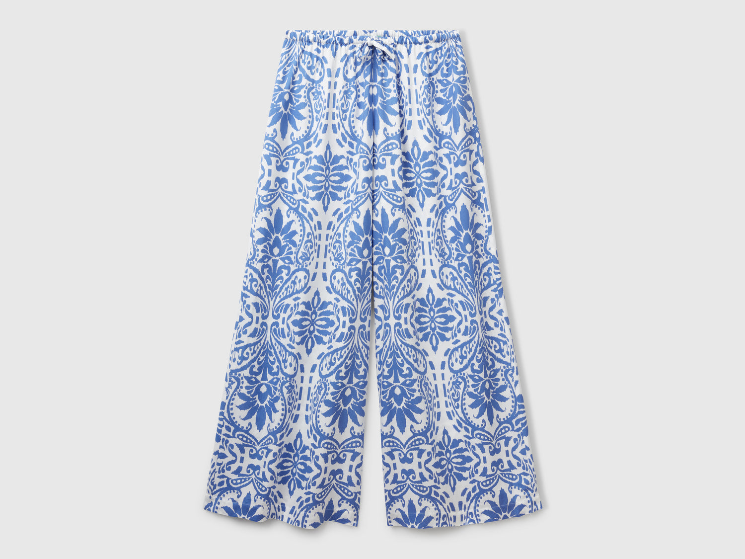 Trousers with patterned print da donna blu | Benetton Outlet