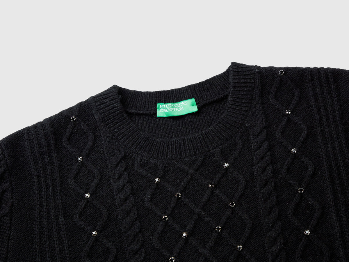 Sweater with braids and rhinestones