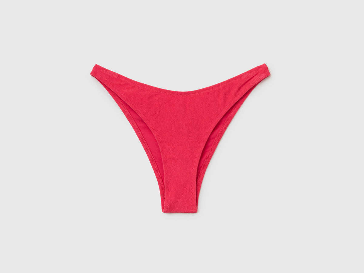 Slip costume con taglio a V in tessuto elasticizzato effetto spugna