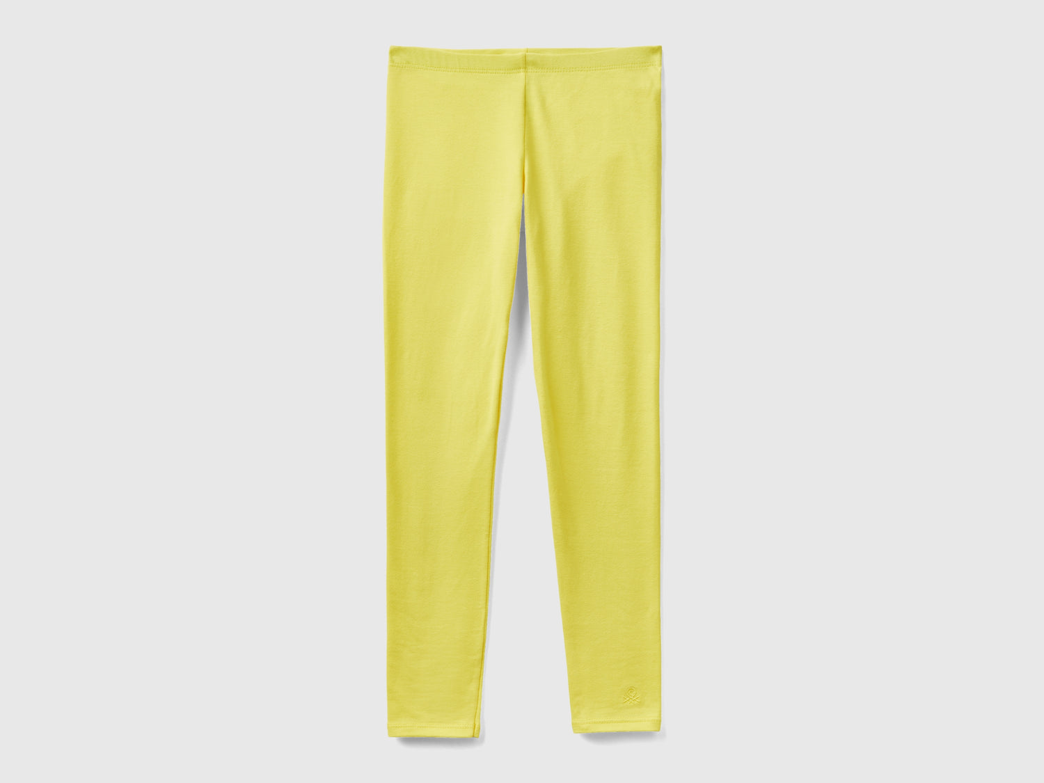 Leggings in cotone stretch con logo da bambina giallo | Benetton Outlet
