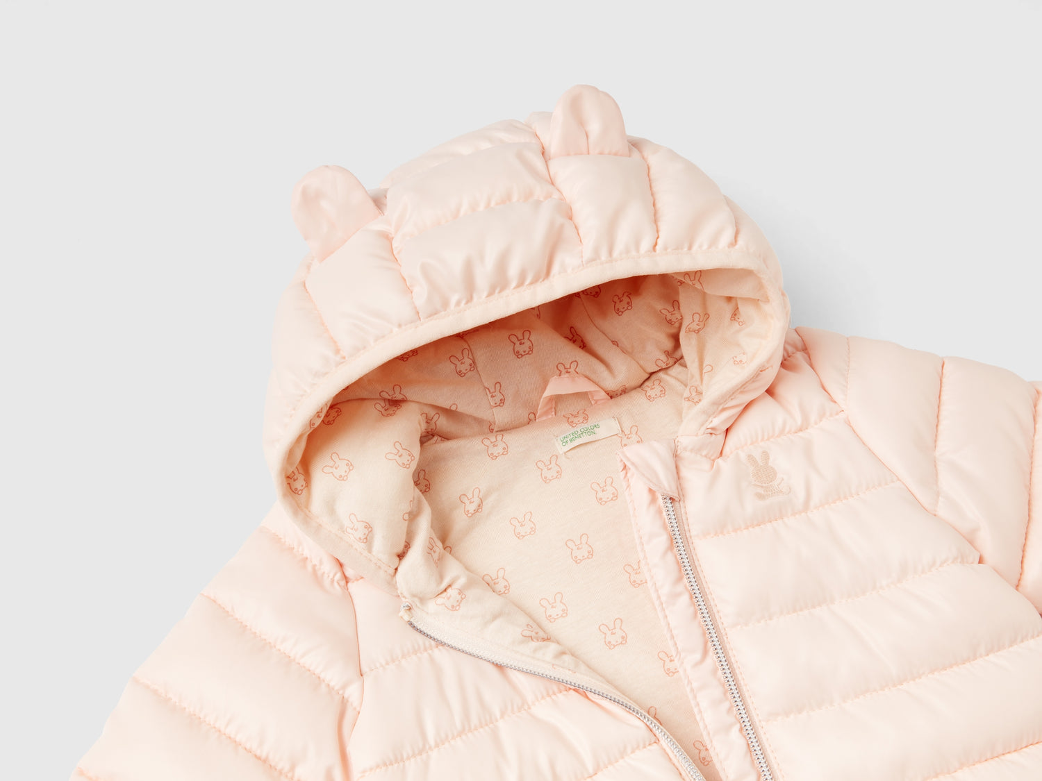 Piumino imbottito con orecchie da neonato pesca | Benetton Outlet