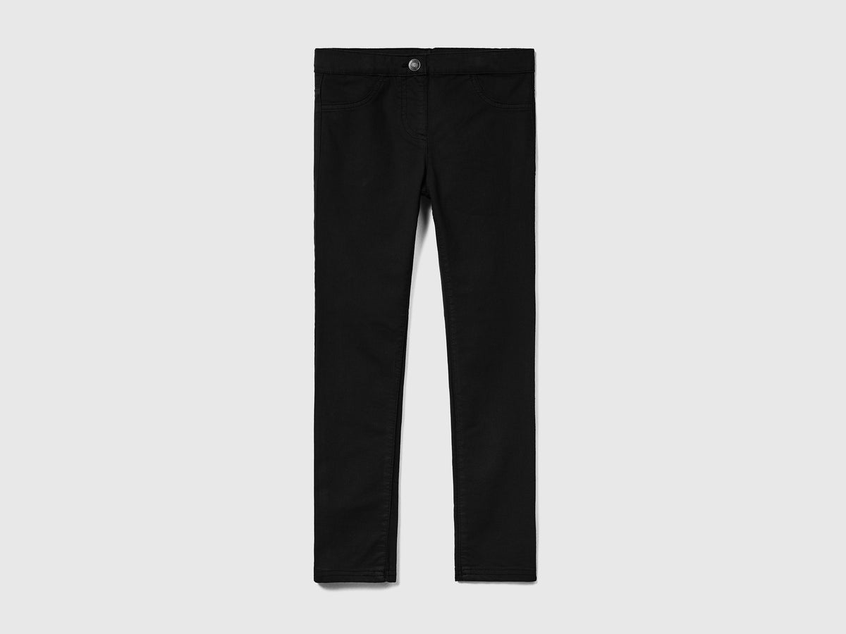 Pantaloni lunghi in misto cotone elasticizzato effetto denim da bambina nero | Benetton Outlet