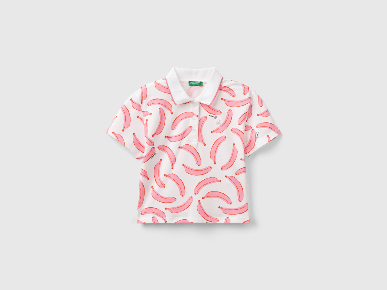 Polo con pattern banane da bambina bianco | Benetton Outlet