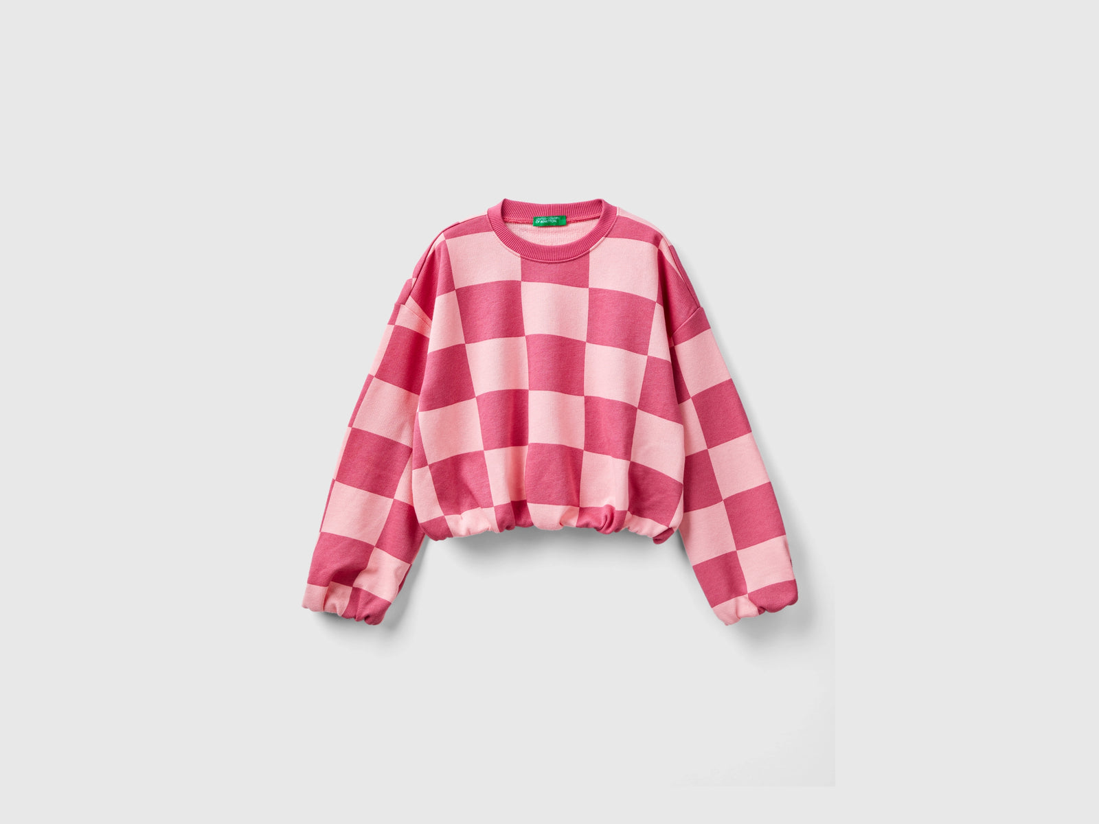 Felpa a scacchi boxy fit da bambina rosa | Benetton Outlet