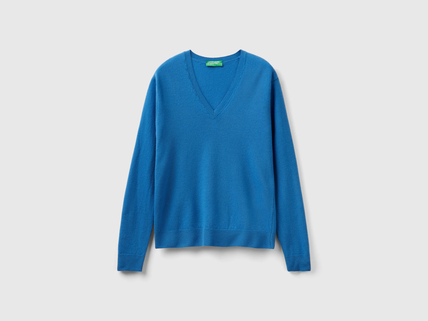 Maglia con scollo a V in pura lana Merino da donna blu | Benetton Outlet