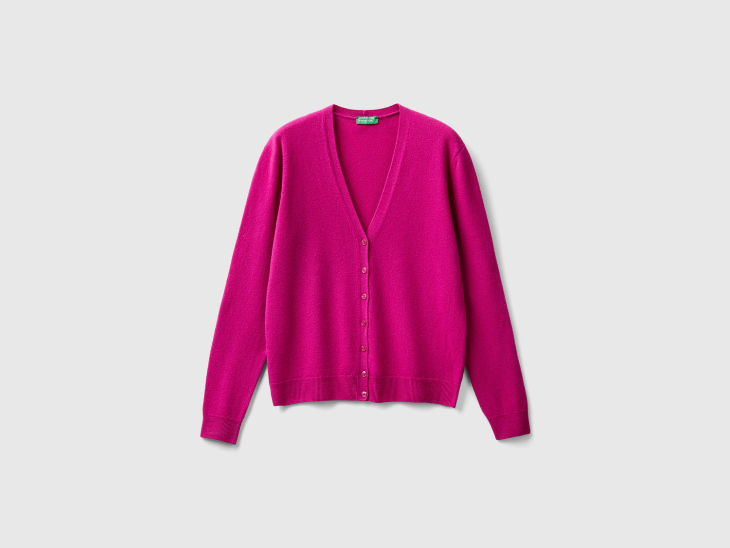 Cardigan scollo a V fucsia in pura lana Merino da donna ciclamino | Benetton Outlet