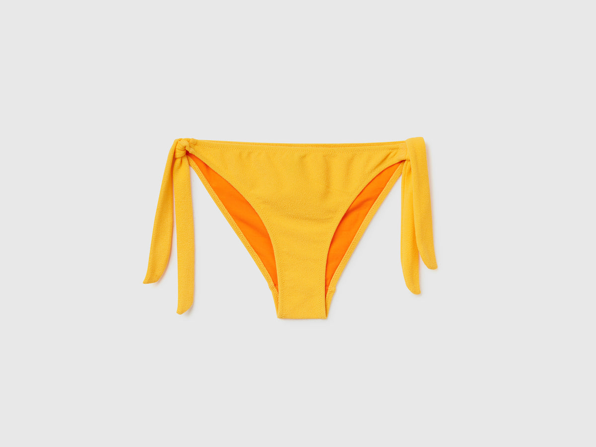 Slip mare con fiocchi sui fianchi in tessuto elasticizzato effetto spugna