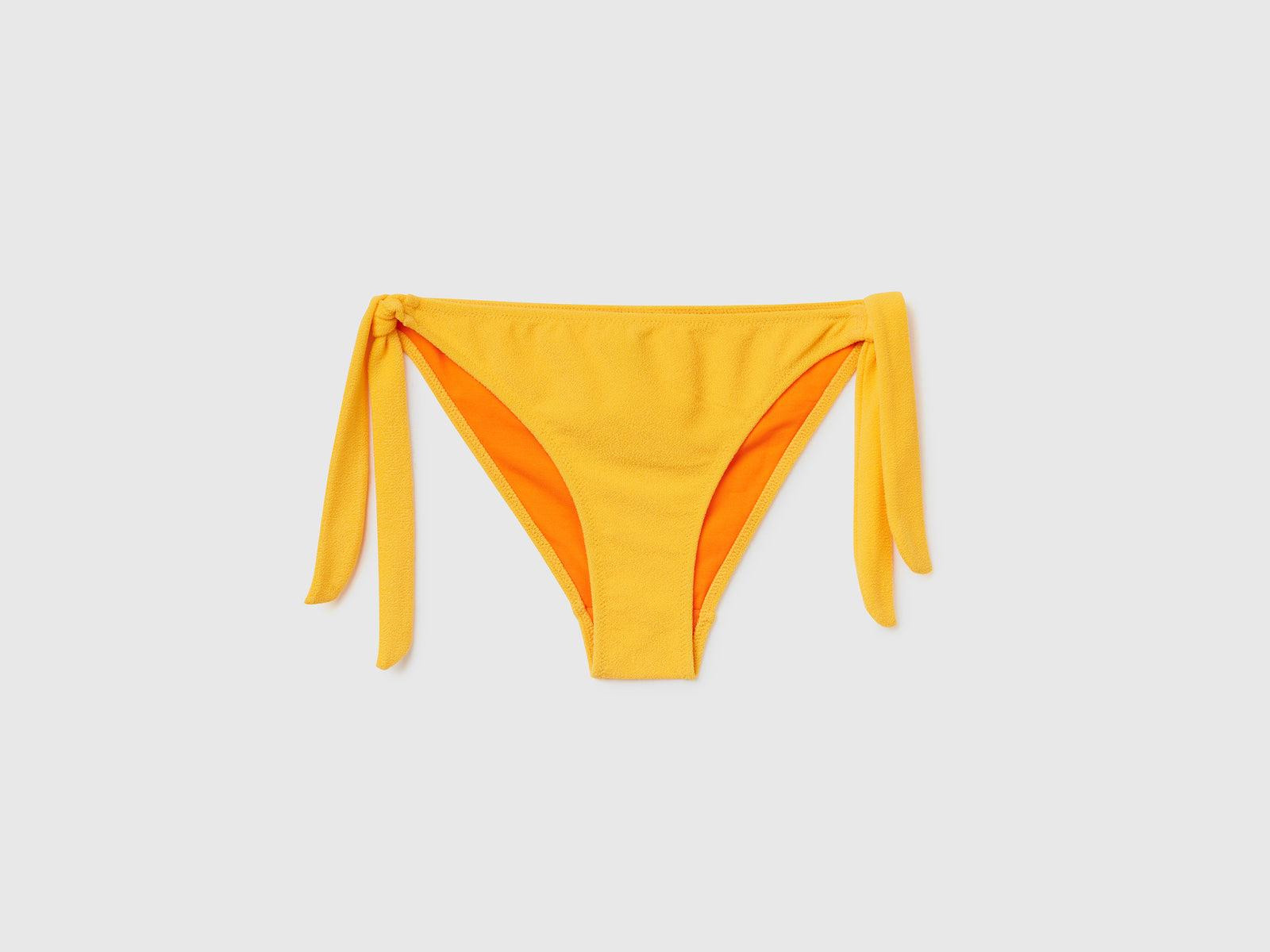 Slip mare con fiocchi sui fianchi in tessuto elasticizzato effetto spugna da donna giallo | Benetton Outlet