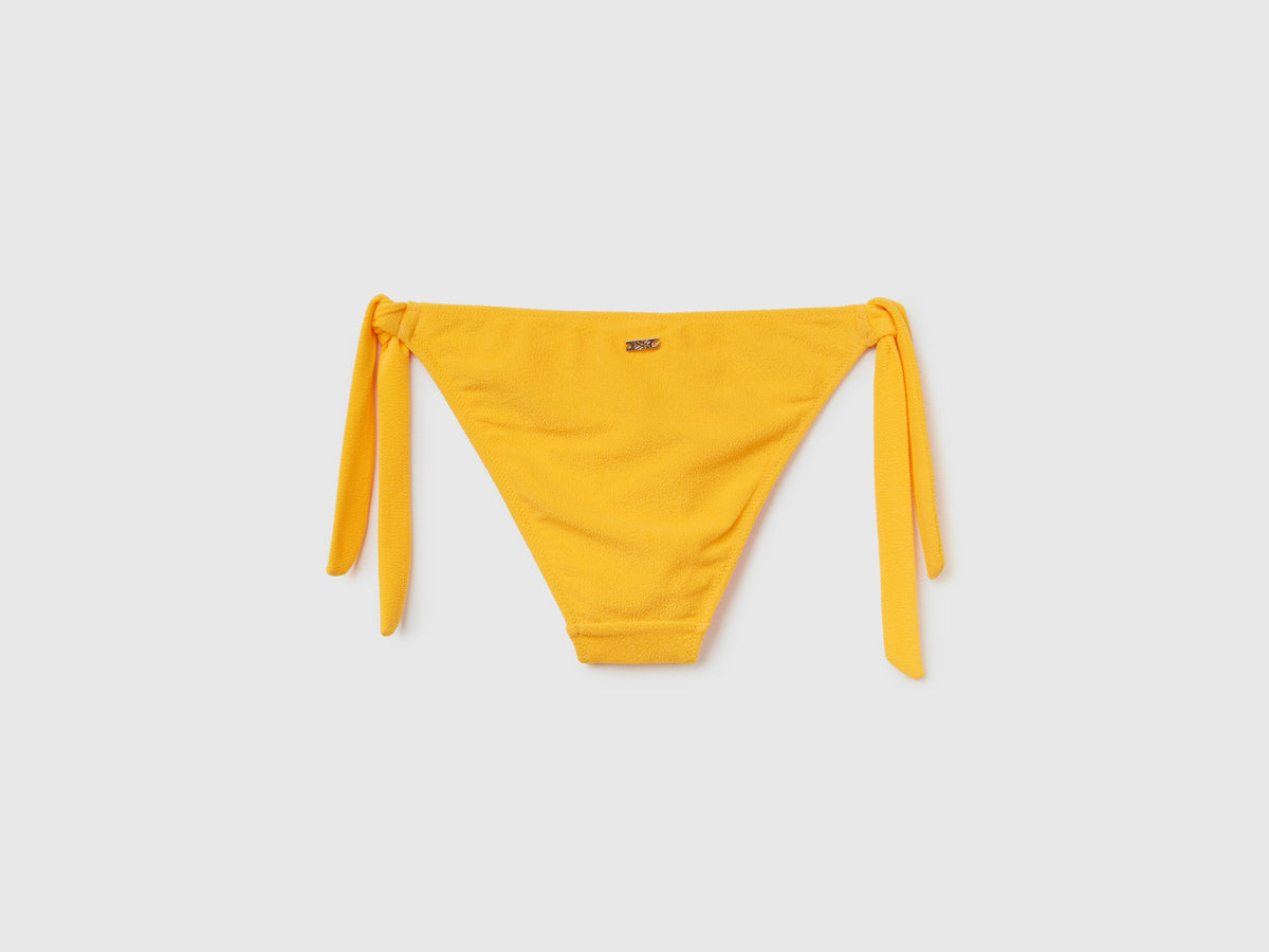 Slip mare con fiocchi sui fianchi in tessuto elasticizzato effetto spugna