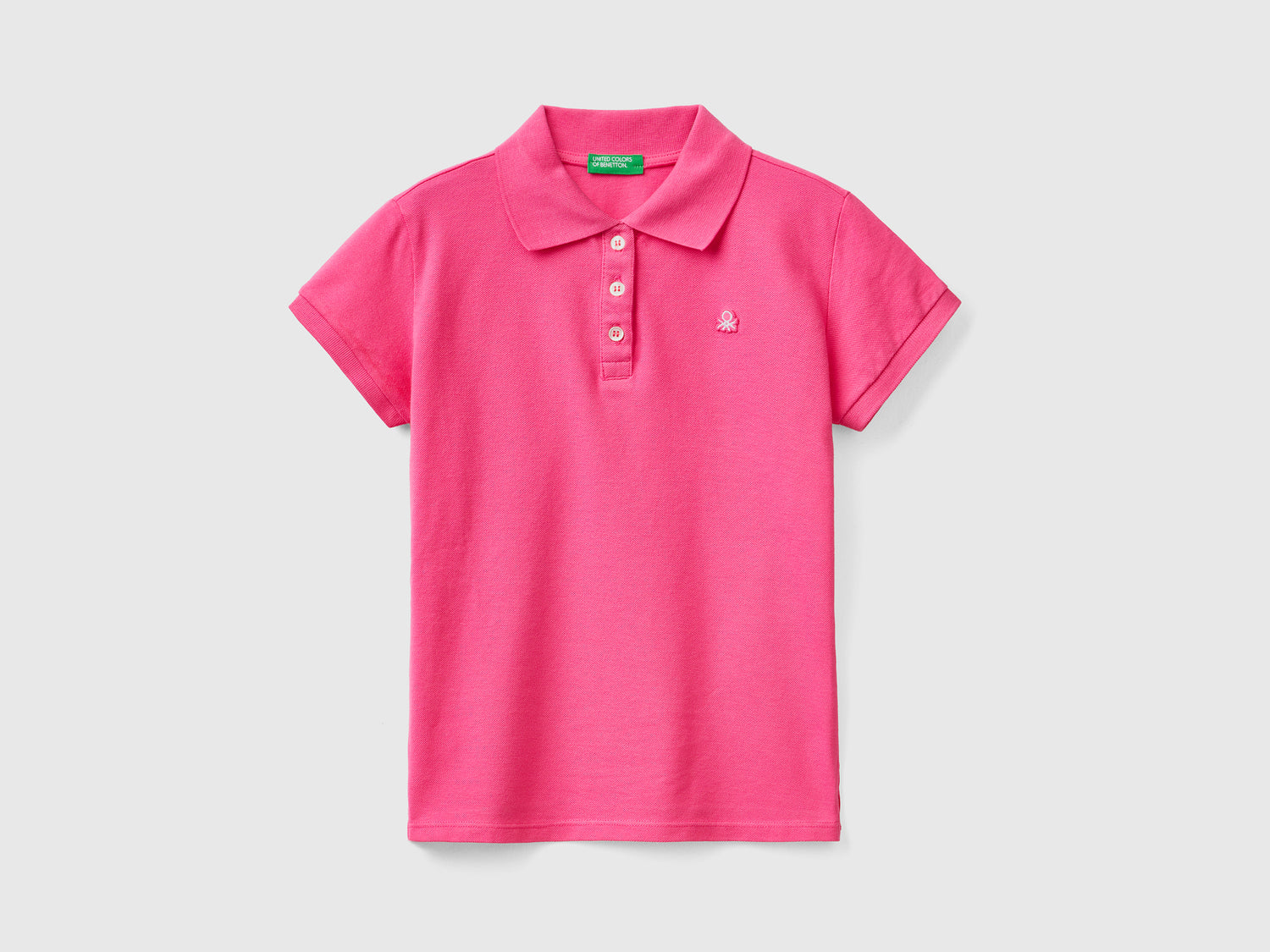 Polo a manica corta in piquet di cotone elasticizzato da bambina fucsia | Benetton Outlet