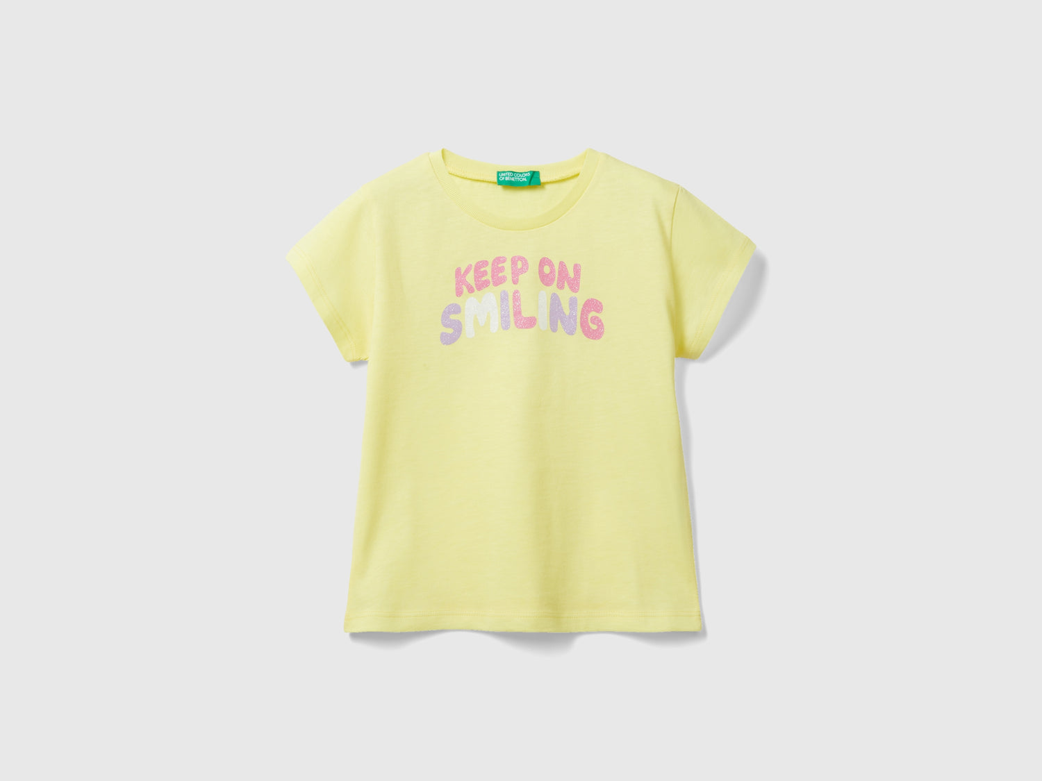 T-shirt in cotone bio con glitter da bimba giallo | Benetton Outlet