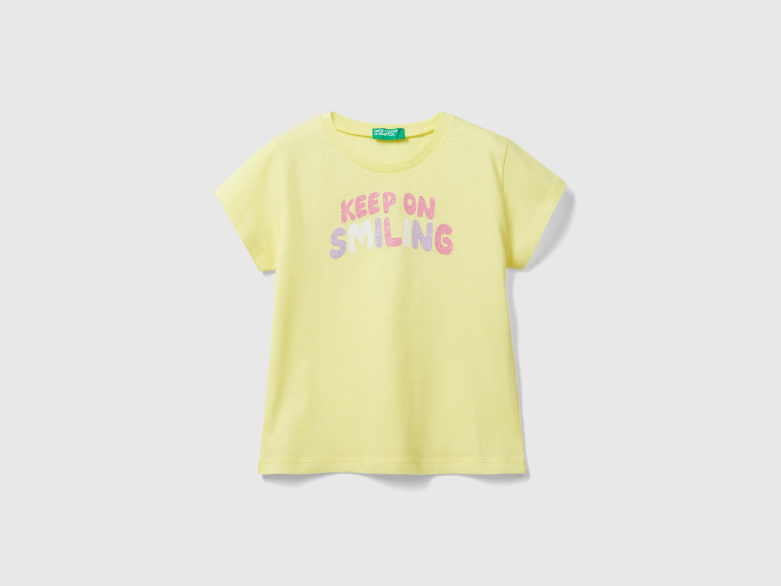 T-shirt in cotone bio con glitter da bimba giallo | Benetton Outlet