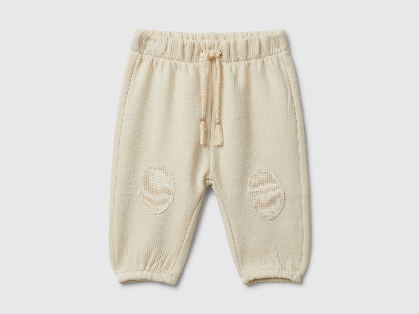 Pantaloni in cotone con patch da neonato beige | Benetton Outlet
