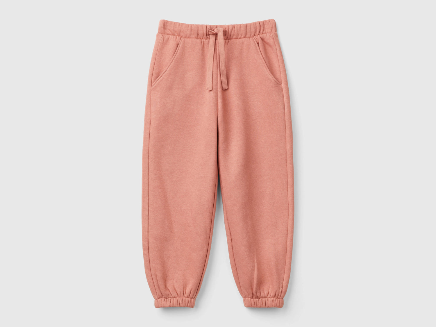 Joggers in felpa con coulisse da bimba salmone | Benetton Outlet
