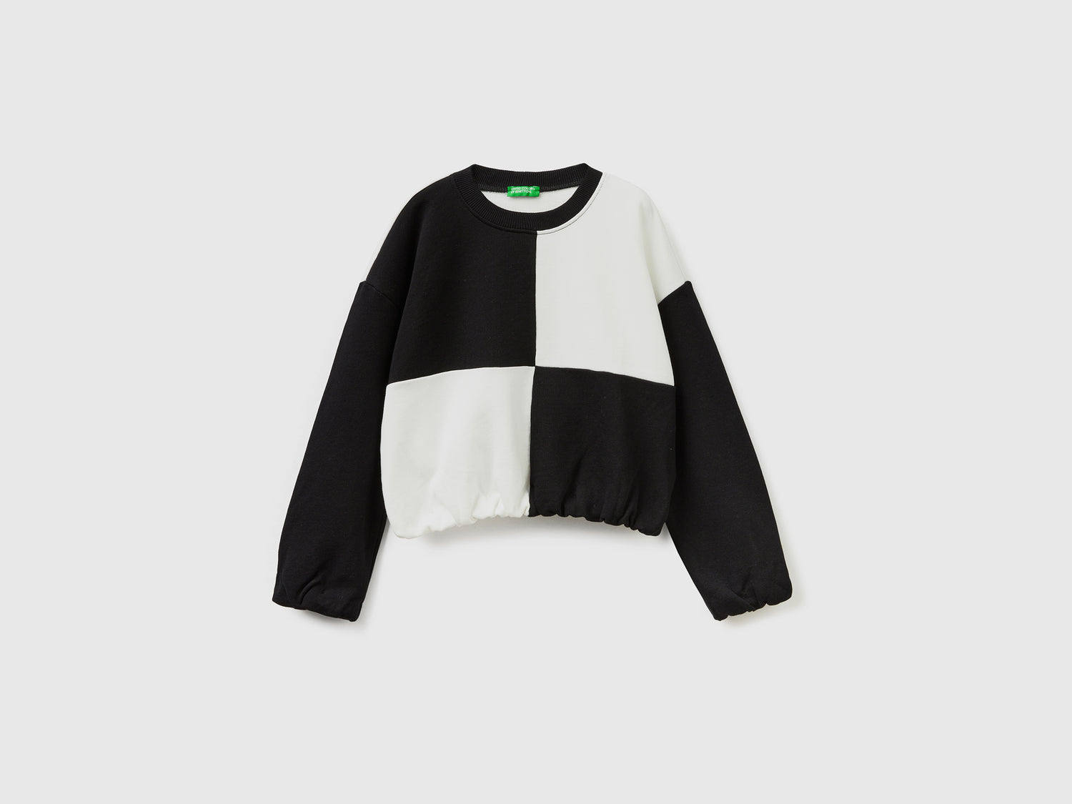Felpa con maxi quadri da bambina bianco | Benetton Outlet